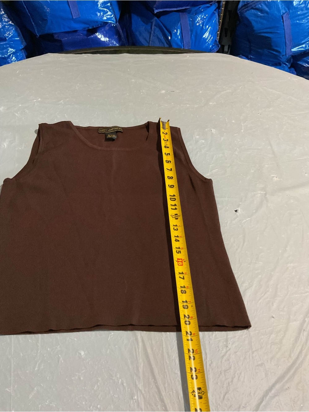 Linda Mathew’s.  
Brown Crewneck Sleeveless Tank Top.